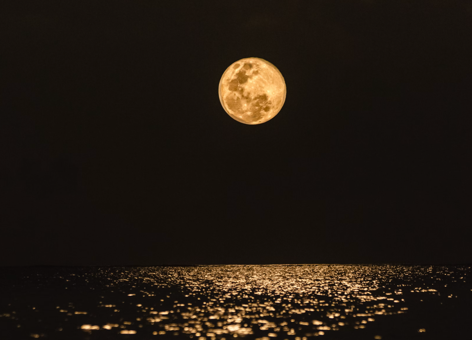 Stunning photo of the moon over pond water